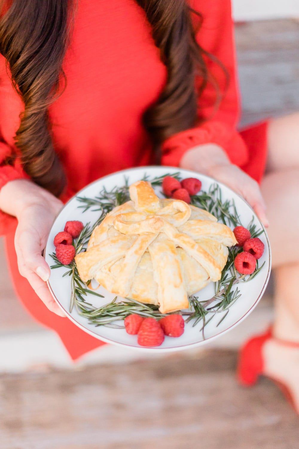 Made with warm and flaky puff pastry dough and flavorful raspberry jam, this “gift-wrapped” raspberry baked brie is the perfect appetizer– and it’s so easy to make, too. Enjoy it by itself or with crackers, apples, or pear slices!