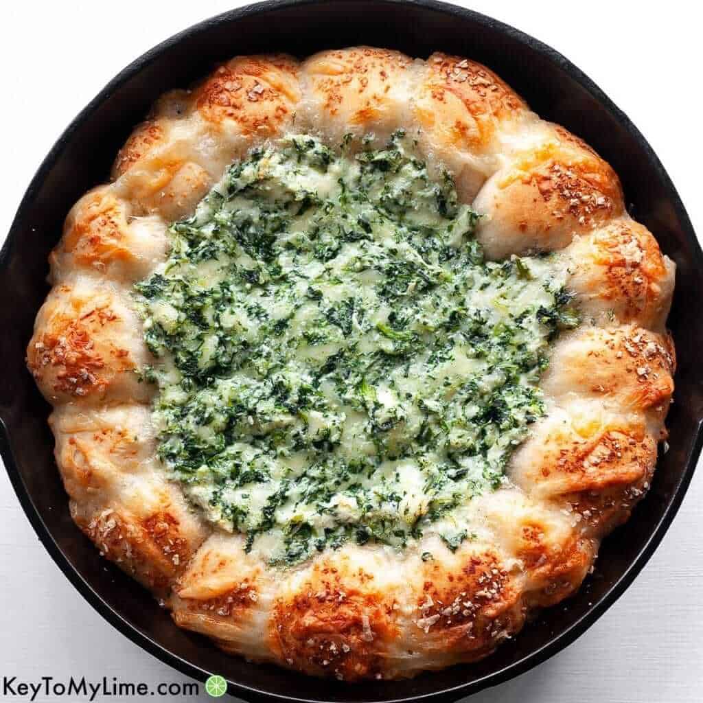 Make this Baked Biscuit Wreath Dip for your next holiday celebration! This spinach dip is nothing short of fantastic. It’s decadent, but not too heavy, and it’s absolutely delicious.