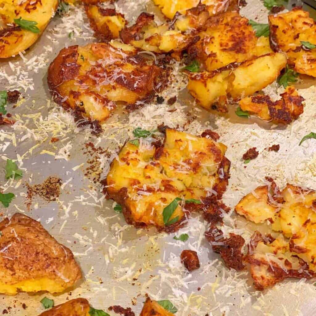 Crispy garlic smashed potatoes that are the perfect finger food appetizer to start your Christmas dinner! You can make them in an oven or an air-fryer, and it's sure to be a hit with the whole family!