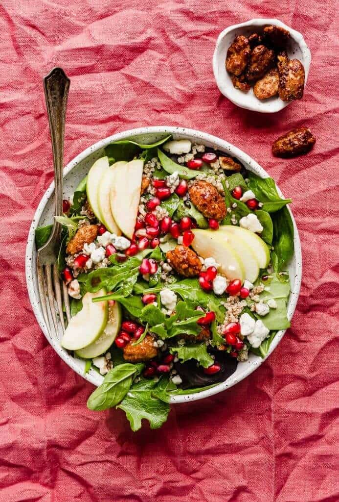 If you’re looking for a festive Christmas appetizer salad then this pomegranate salad is for you! Packed with pomegranate seeds, candied pecans, Gorgonzola cheese, apples, cooked quinoa, and a delicious pomegranate salad dressing, this salad is healthy, festive, and oh-so tasty!