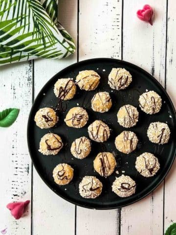 Gorgeous mascarpone eggnog cookies, rolled in ladyfinger crumbs and drizzled with chocolate sauce.