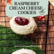 Gorgeous raspberry cream cheese thumbprint cookies on black cooling rack.