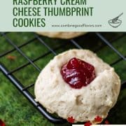 Gorgeous raspberry cream cheese thumbprint cookies on black cooling rack.