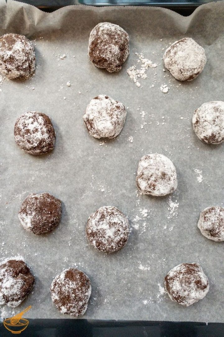 Ball shaped and sugar covered cookie dough balls. Placed on the prepared baking sheet.