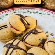 Egg yolk cookies, assembled with strawberry jam and drizzled with dark chocolate couverture.