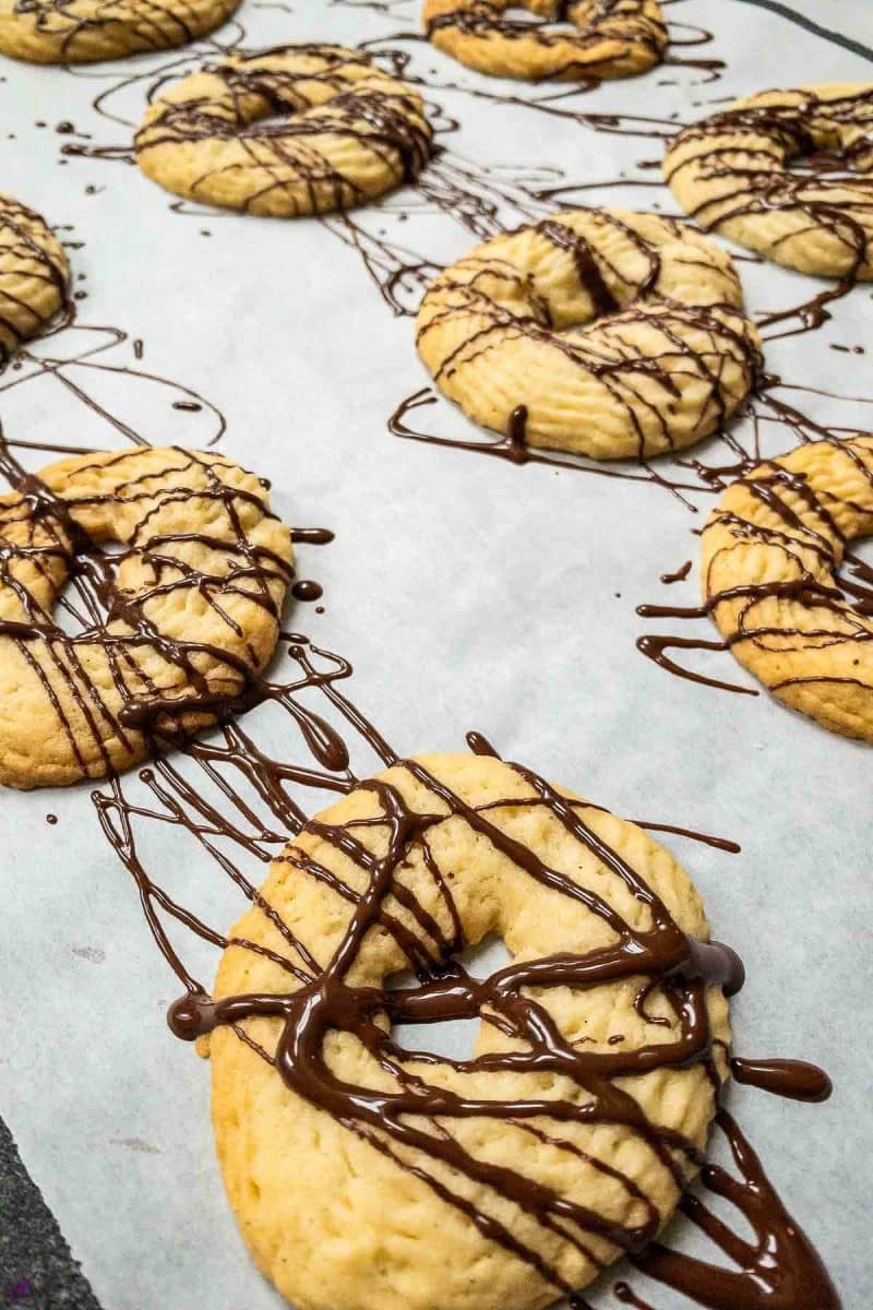 Butter cookies drizzled with dark chocolate couverture.