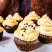 Boozy Baileys Salted Caramel Cupcakes with a delicious chocolate Sponge! Sprinkled with chocolate balls and caramel crunch.