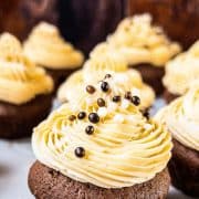 Boozy Baileys Salted Caramel Cupcakes with a delicious chocolate Sponge! Sprinkled with chocolate balls and caramel crunch.