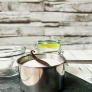 1 Cup sugar with vanilla bean on top.