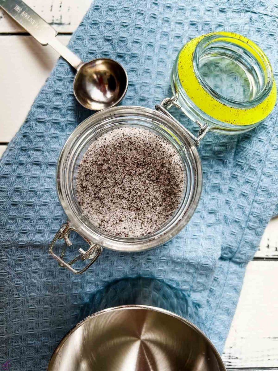 Preserving jar filled with a mix of granulated sugar and vanilla powder.