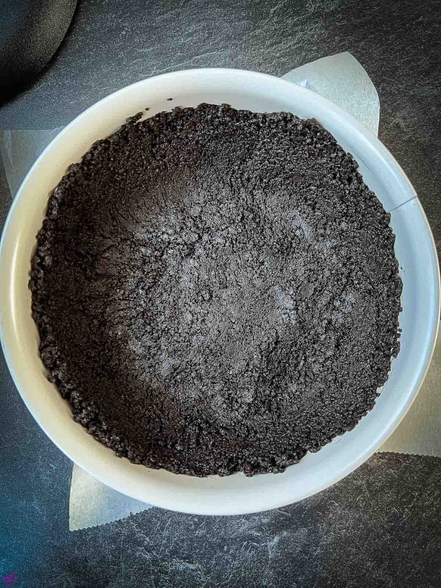 Oreo dough pressed firmly into the springform pan. 