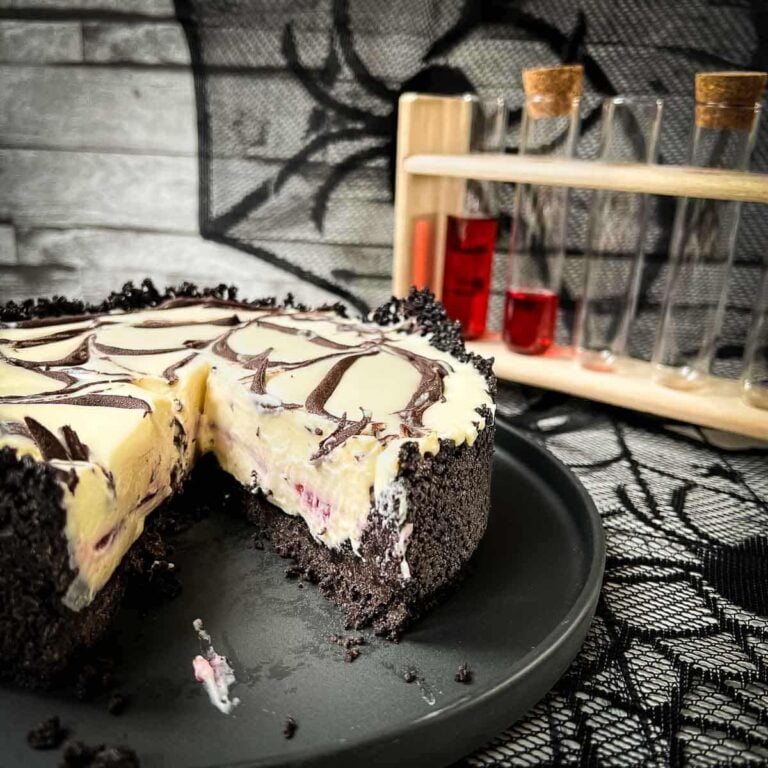 Slice of no bake raspberry Oreo cheesecake on a black plate.