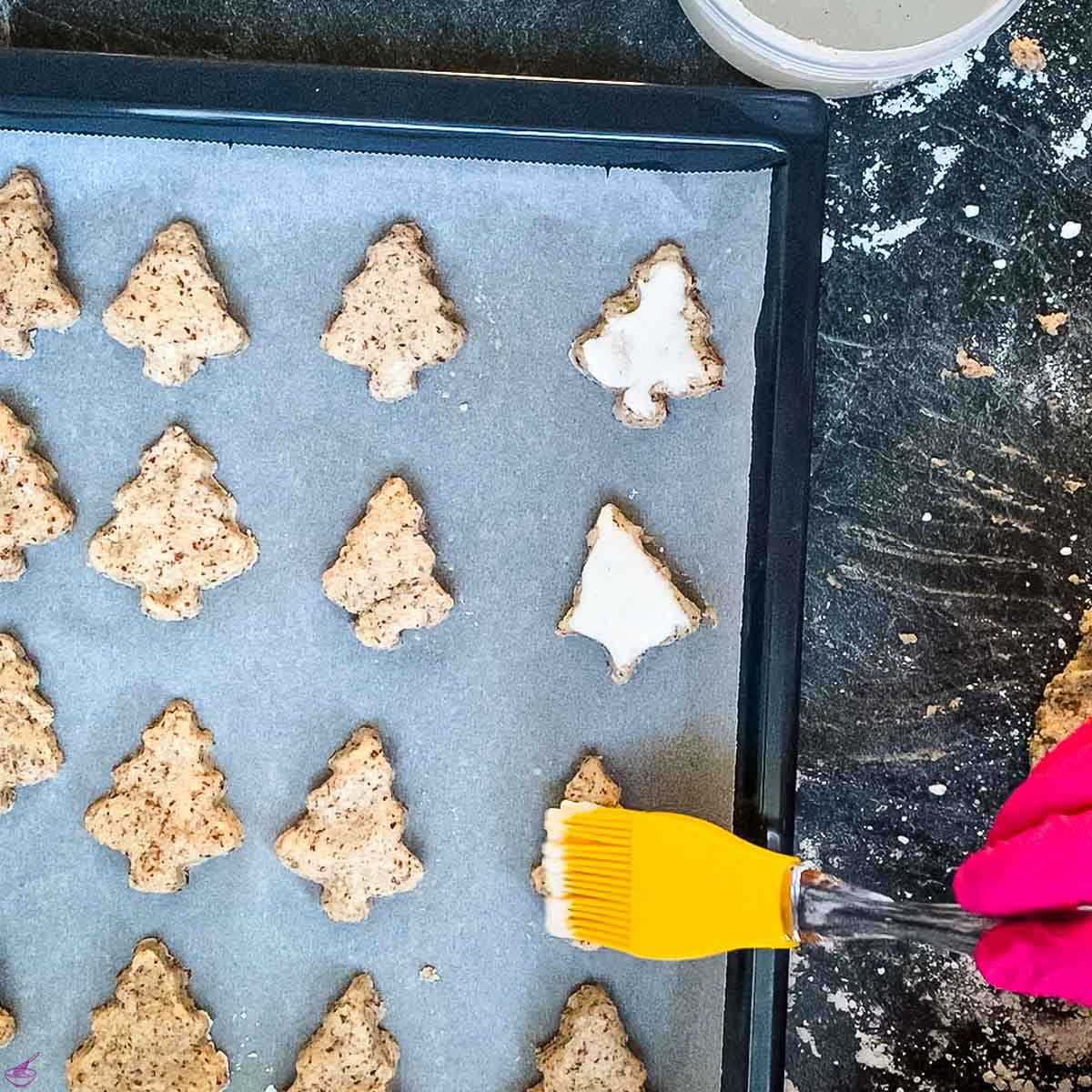 Brush the cut out trees with the sugar egg white mixture.