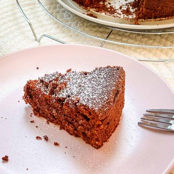 A slice of deliciousness! Flourless chocolate cake dusted with powdered sugar.