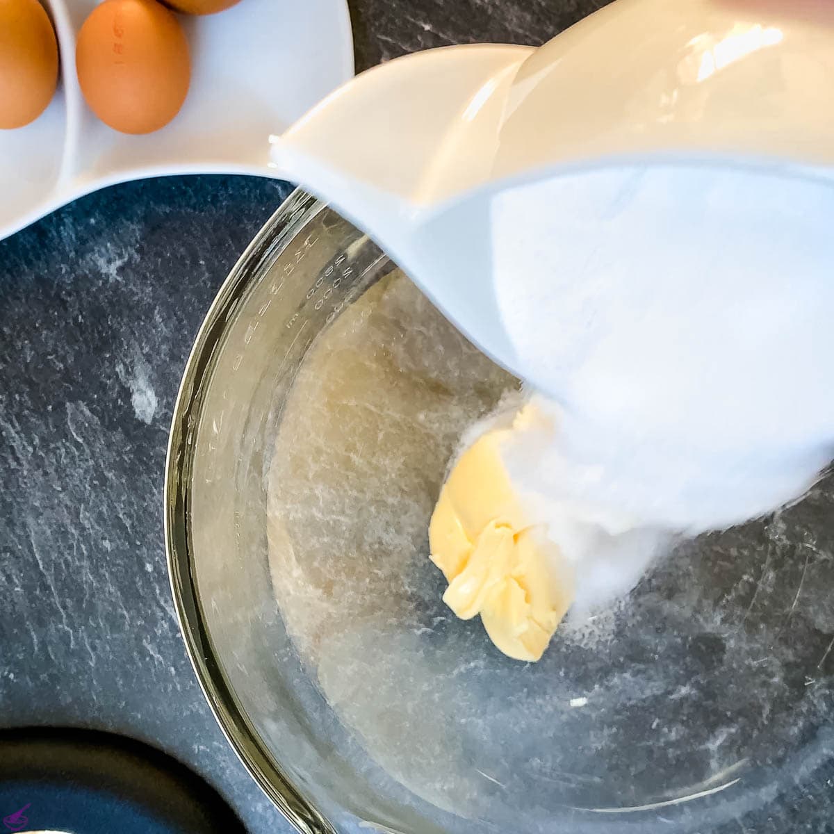 Add sugar and soft butter to the mixing bowl.