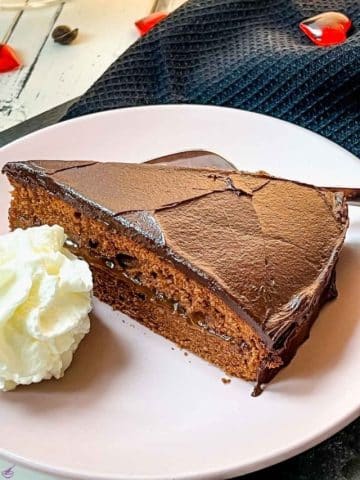 Serve a delicious slice of Sacher cake with a dollop of whipped cream.