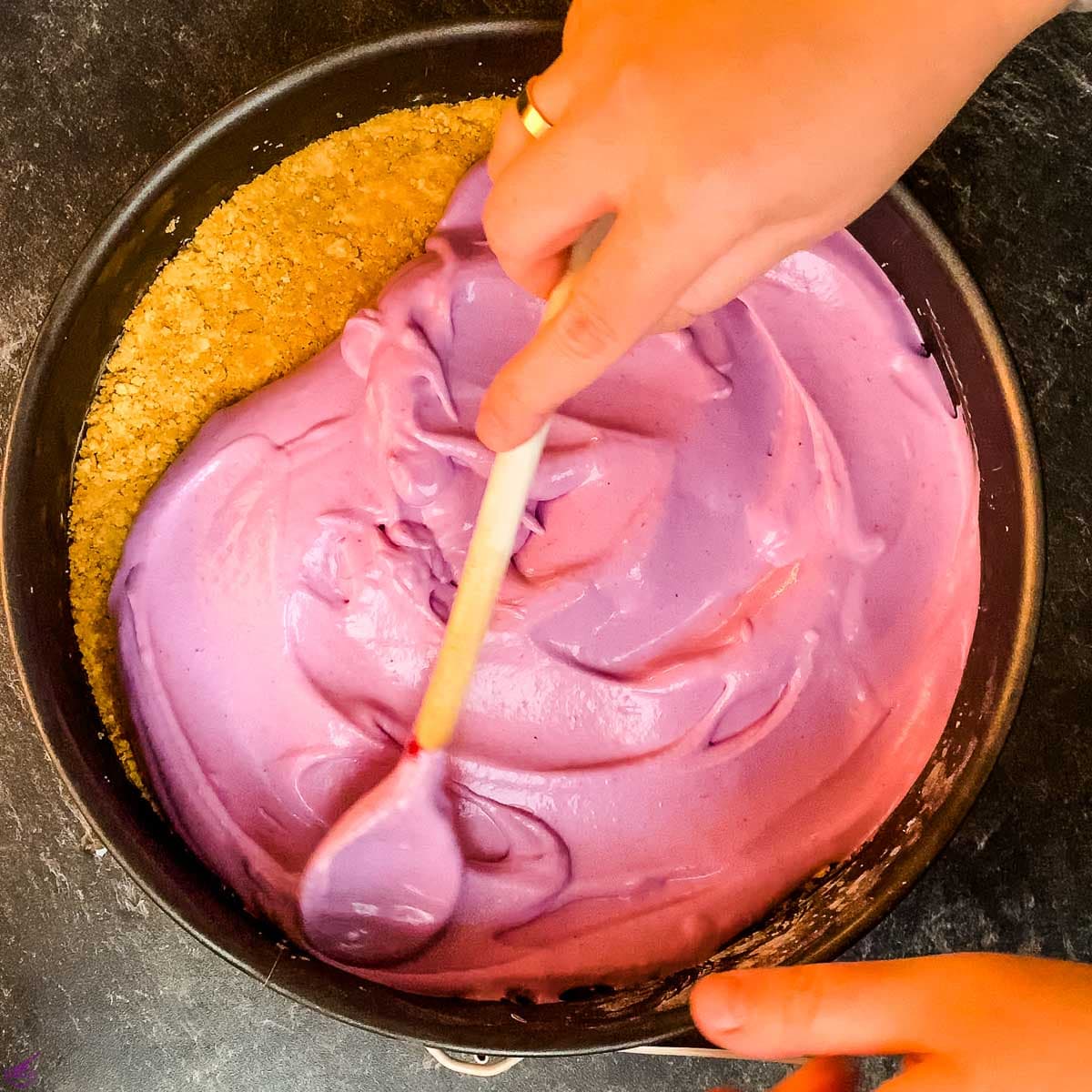 Spread the blueberry layer on top of the graham cracker walnut base.