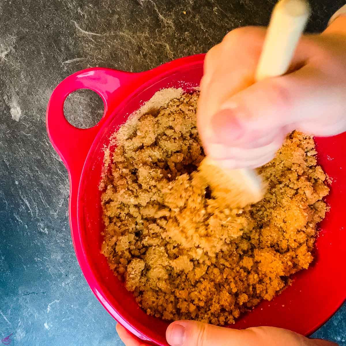 Combine the melted butter with the graham cracker crumbs and ground walnuts.