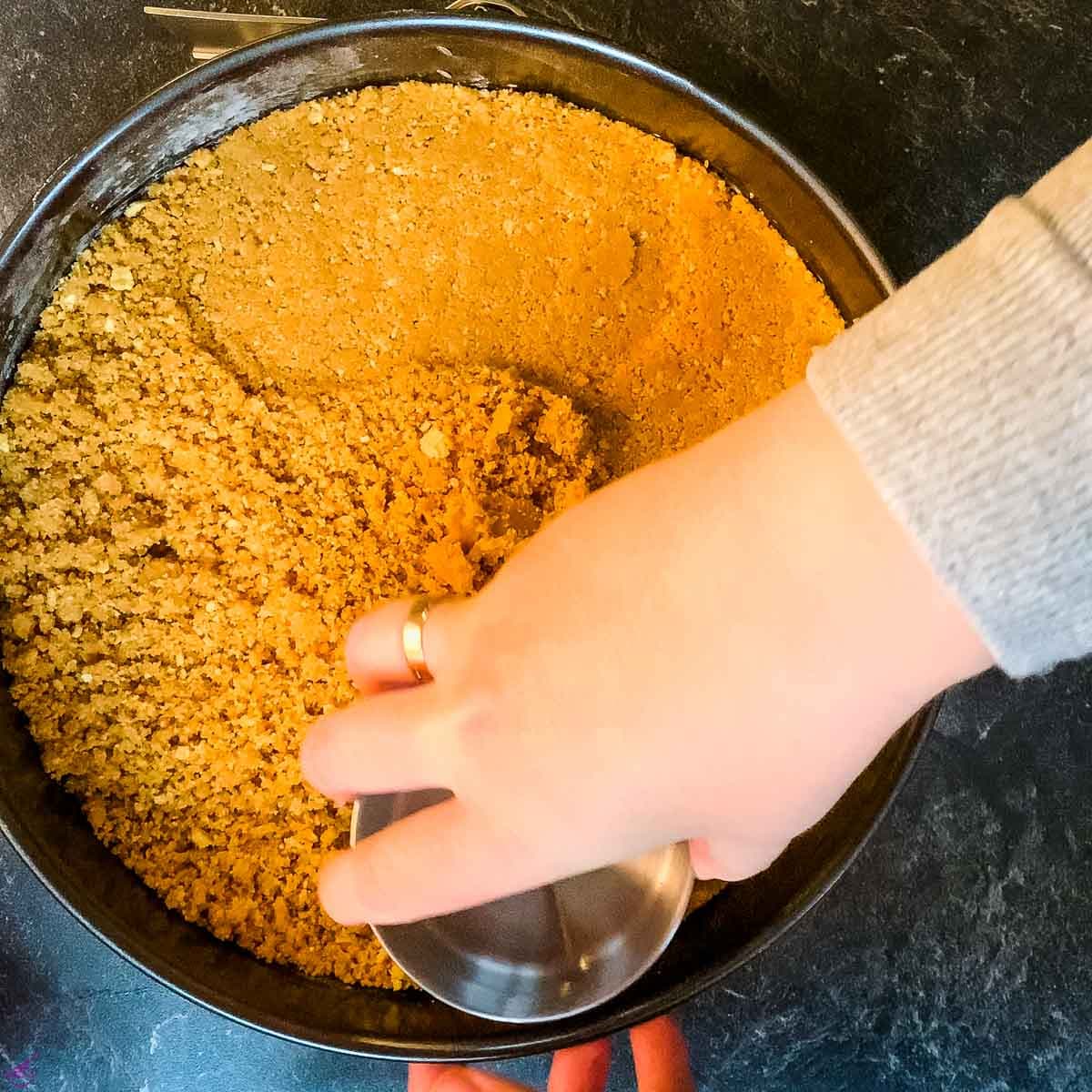 Press the walnut graham cracker crumbs firmly into the springform pan.