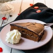 Serve a delicious slice of Sacher cake with a dollop of whipped cream.
