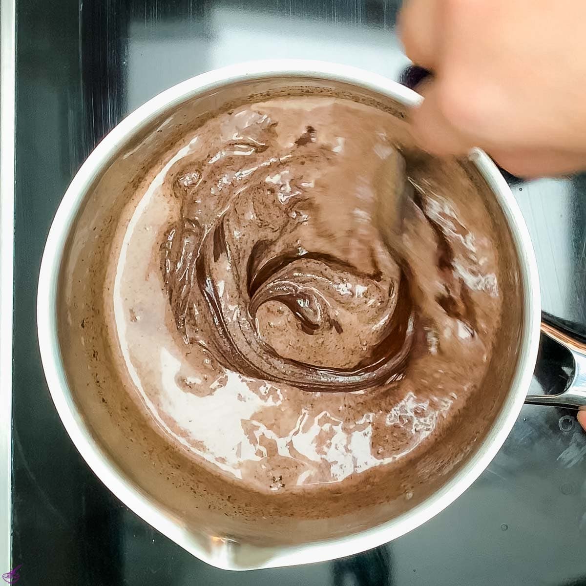 Add the chocolate couverture to the hot heavy cream.