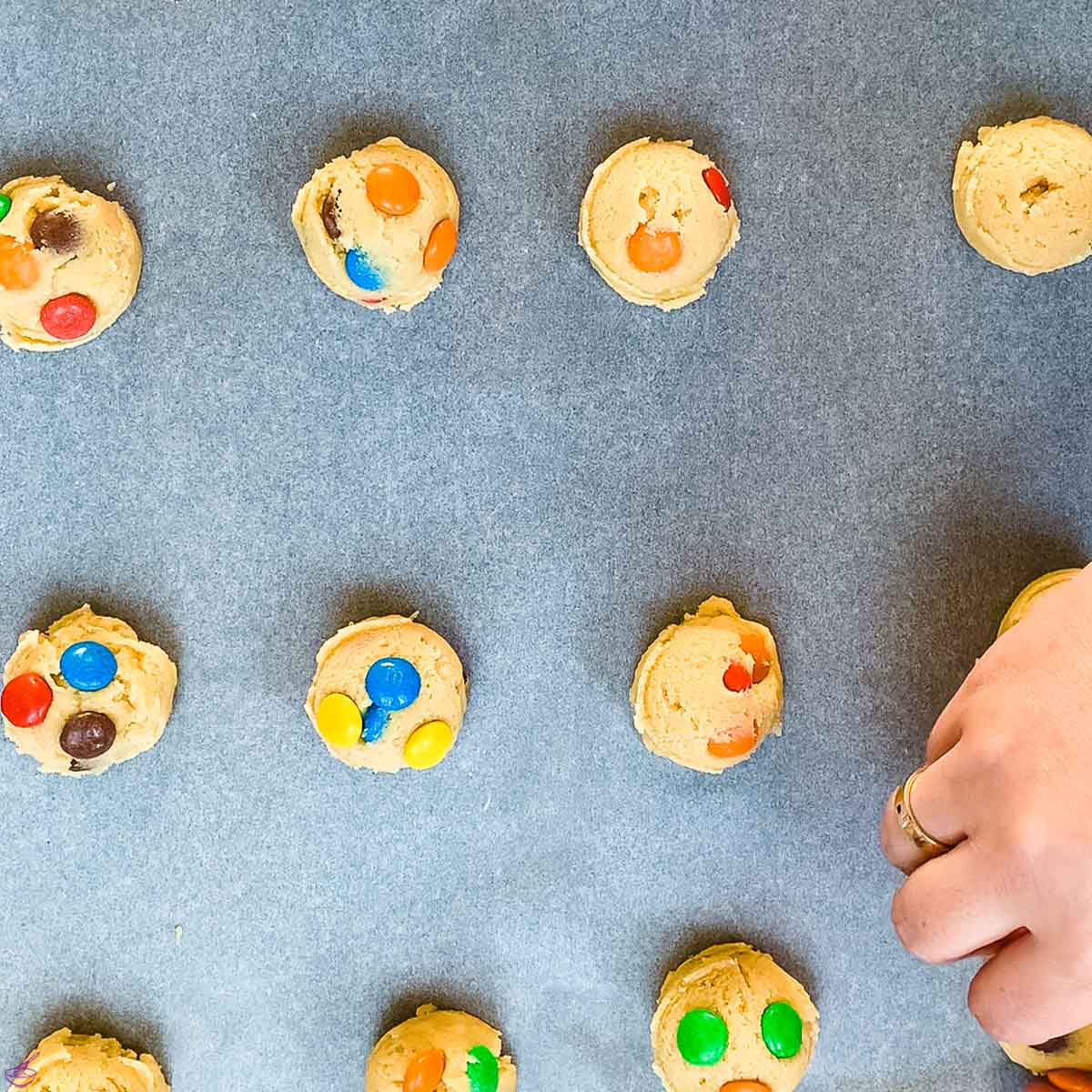 Spread the remaining M and Ms over the cookie balls. You'll need to press down a bit, so they don't fall off.