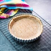 Tart Crust with Walnuts placed in tart form.