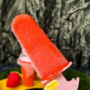 Close-up of a strawberry popsicle on flamingo popsicle stick.