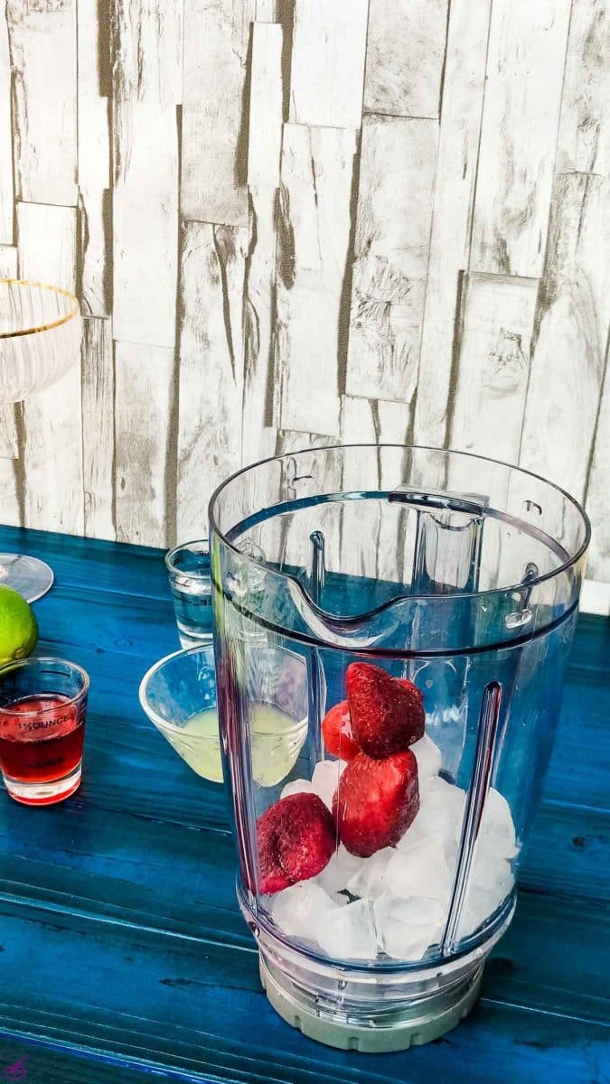 Add the strawberries to the blenders' container.