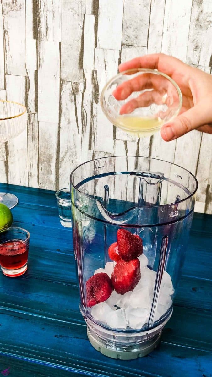 Add the freshly squeezed lemon juice to the blenders' container.