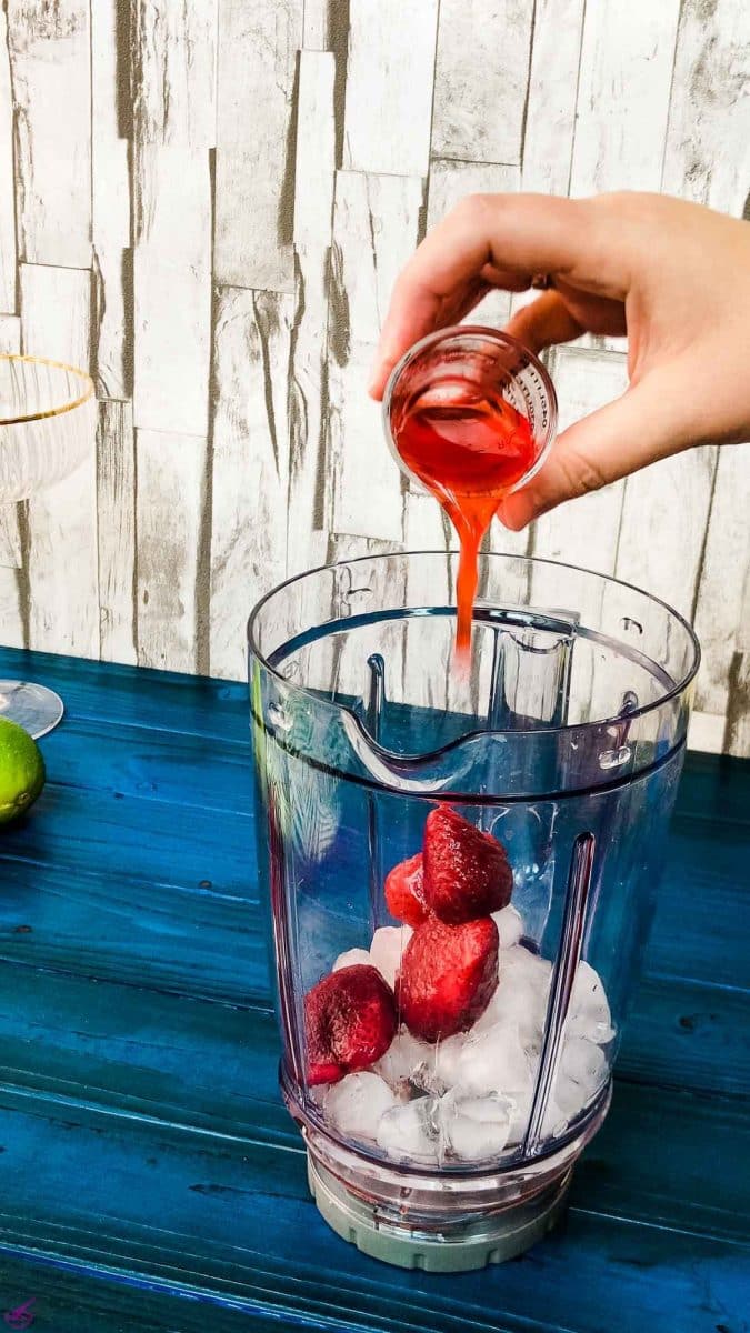 Add the homemade strawberry simple syrup to the blenders' container.