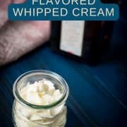 A tulip Weck jar filled with delicious orange flavored whipped cream on dark blue wooden floor.