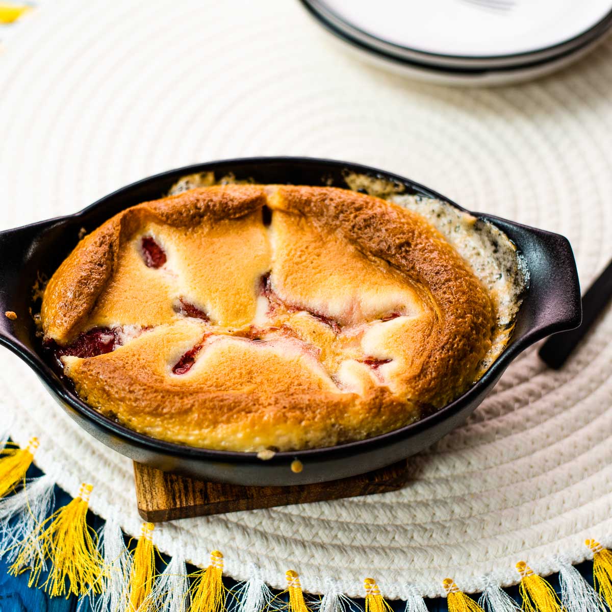 Delicious strawberry cobbler in black mini casserole pan.