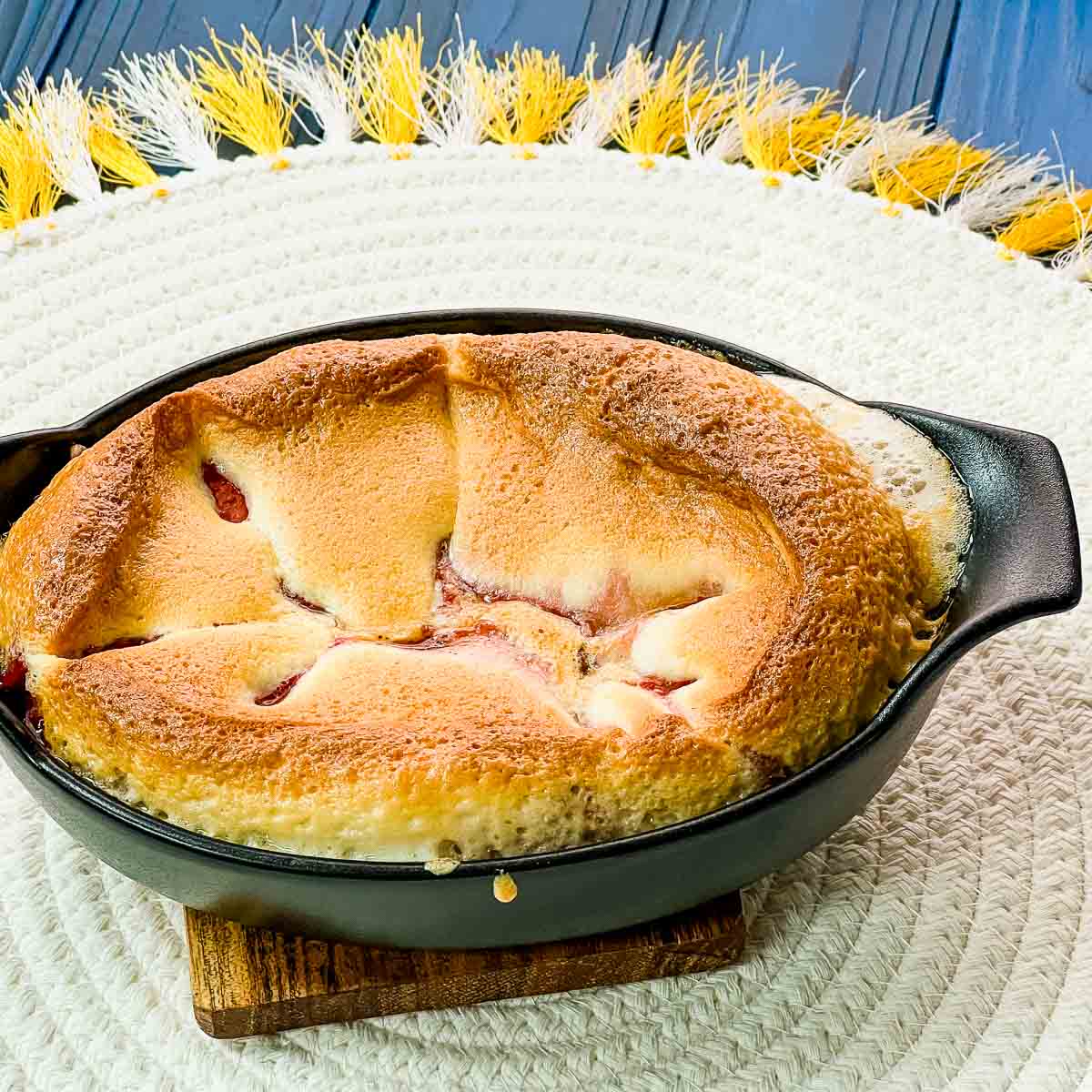 Delicious strawberry cobbler in black mini casserole pan.