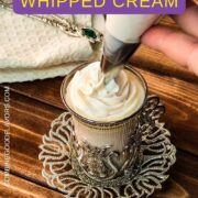 Piping a wonderful rosette of delicious strawberry flavored whipped cream on top of a cup of your favorite beverage.