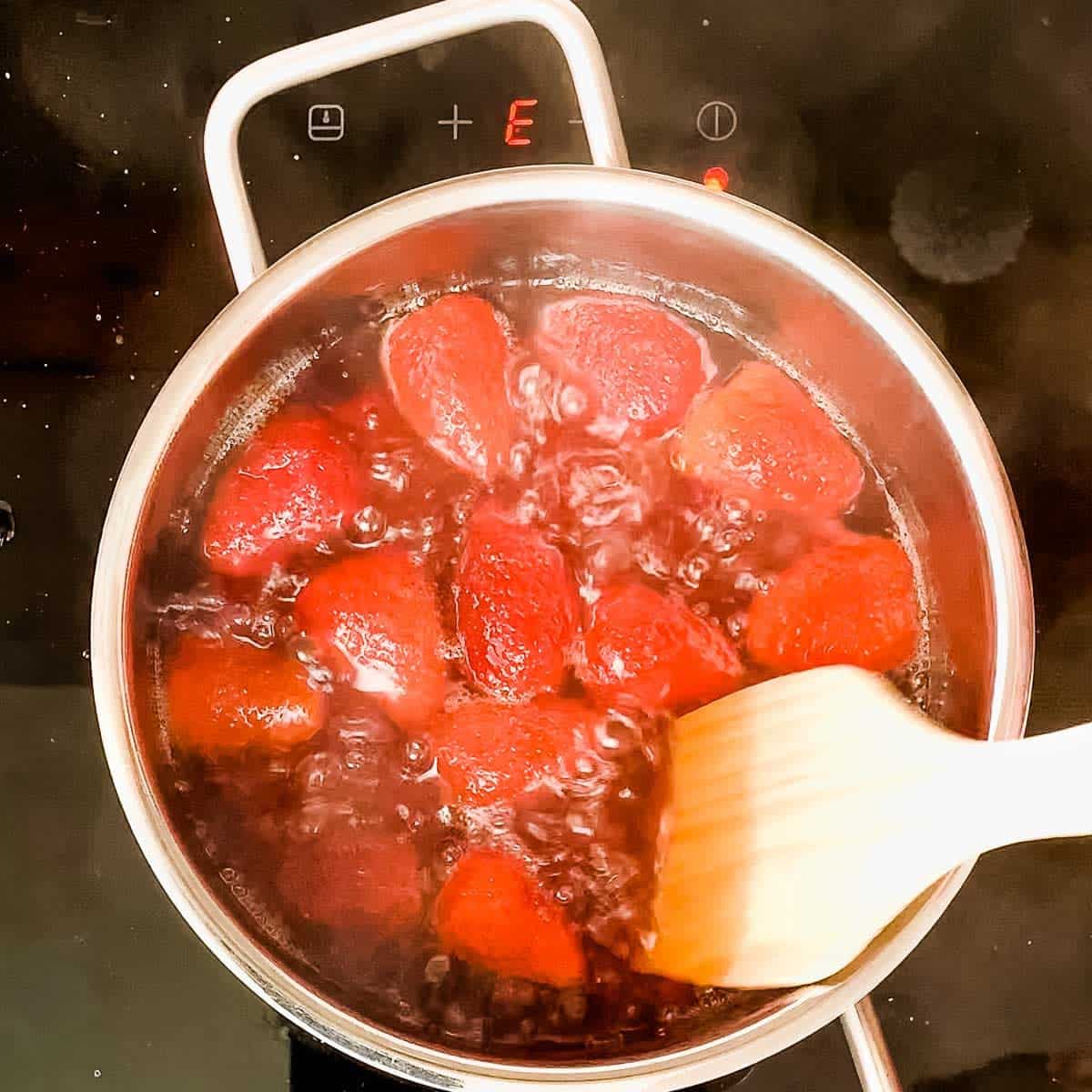 Cook the strawberry mixture until the sugar is fully dissolved.