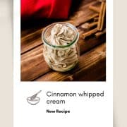 Gorgeous cinnamon whipped cream, in tulip formed Weck glass on a wooden floor.