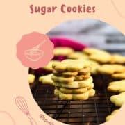 Gorgeous sugar cookies stacked beautifully on a cooling rack.