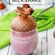 Delicious creamy strawberry milkshake with only four ingredients in a beautiful pineapple-shaped cocktail glass.