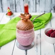 Delicious creamy strawberry milkshake with only four ingredients in a beautiful pineapple-shaped cocktail glass.
