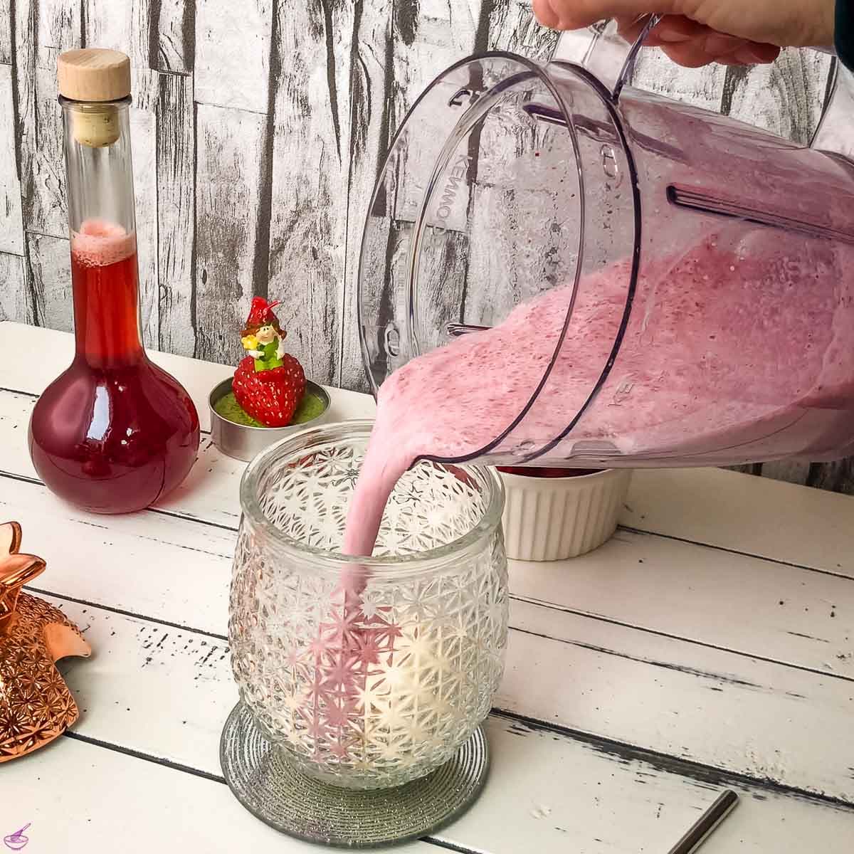 Pour the strawberry milk and strawberry syrup mixture over the vanilla ice cream in the cocktail glass.