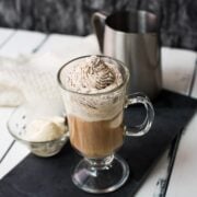 Beautiful glass filled with delicious vanilla iced coffee. Topped with chocolate-flavored whipped cream.