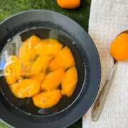 Black bowl filled with a healthy and delicious apricot compote.