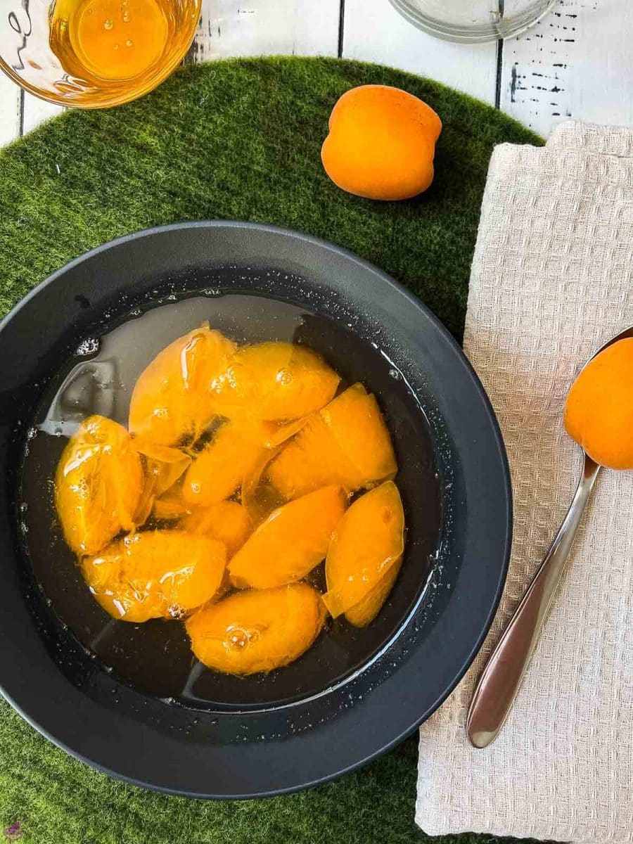 Black bowl filled with a healthy and delicious apricot compote.