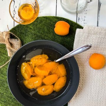 Black bowl filled with a healthy and delicious apricot compote.