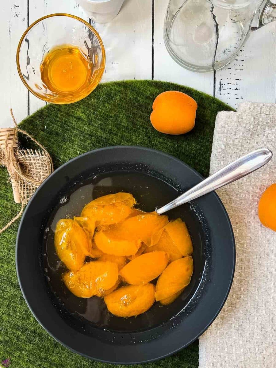 Black bowl filled with a healthy and delicious apricot compote.