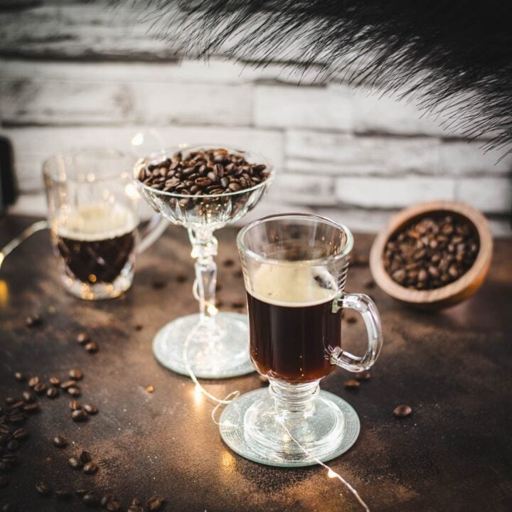 Three gorgeous glasses. Two filled with coffee, centered on filled with coffee beans.