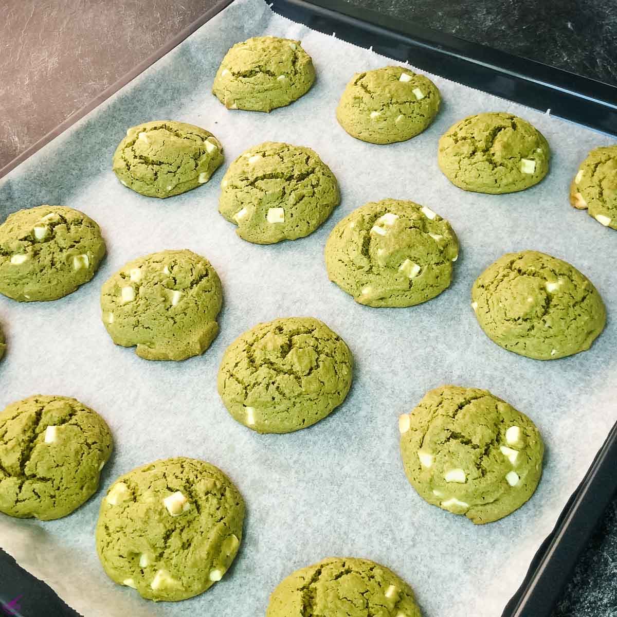 Matcha cookies after baking on the baking sheet.