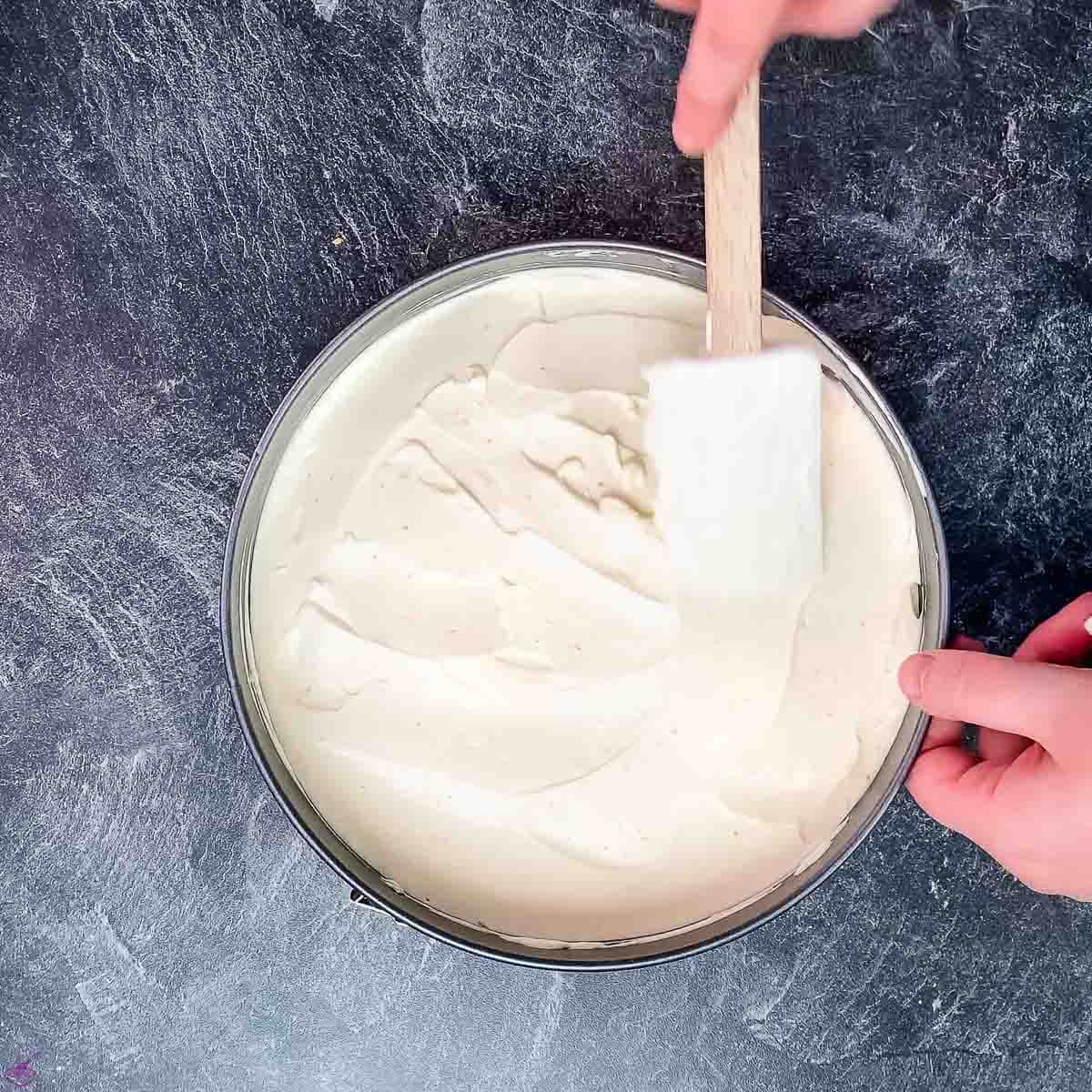 Spread the lemon cheesecake filling on top of the graham cracker crust.