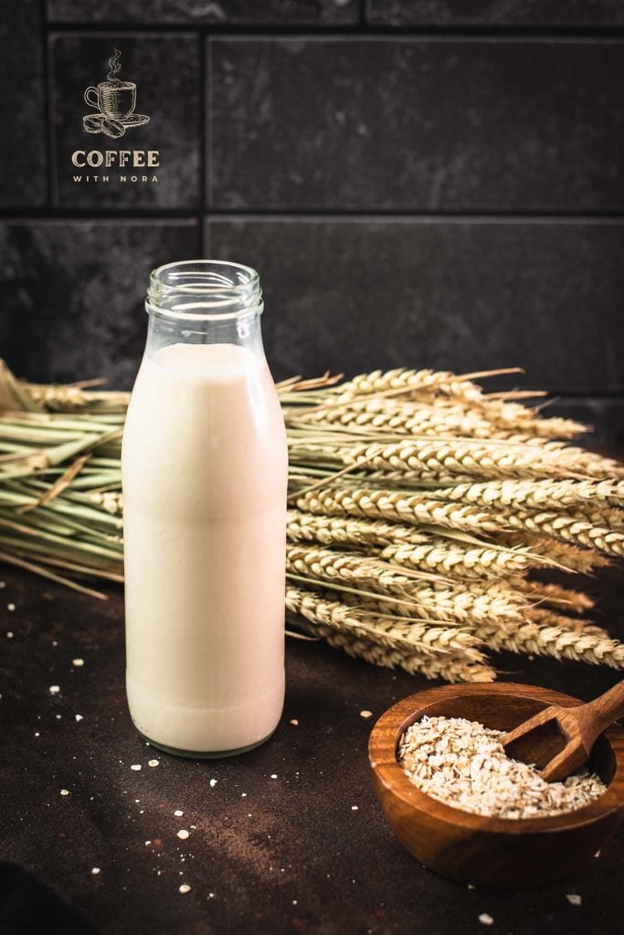 Milk bottle with oat milk on dark background.